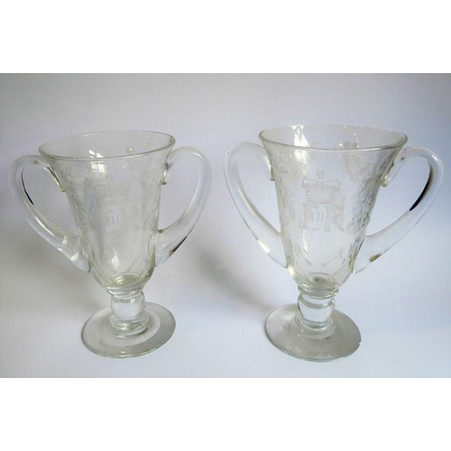 75 - A pair of mid-20th century two-handled clear-glass vases foliates engraved and with the cypher of El... 