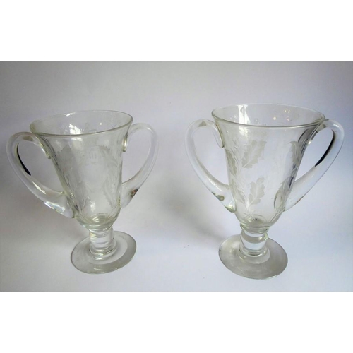 75 - A pair of mid-20th century two-handled clear-glass vases foliates engraved and with the cypher of El... 