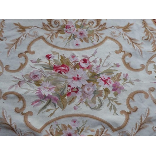 756 - An unlined Aubusson tapestry with a floral geometric pattern in red and cream/gold ornamented with p... 