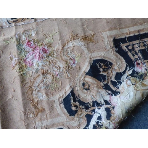 757 - An unlined Aubusson tapestry in a floral geometric pattern in black and beige with a central floral ... 