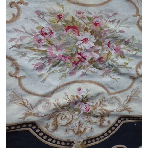 757 - An unlined Aubusson tapestry in a floral geometric pattern in black and beige with a central floral ... 