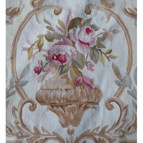 757 - An unlined Aubusson tapestry in a floral geometric pattern in black and beige with a central floral ... 