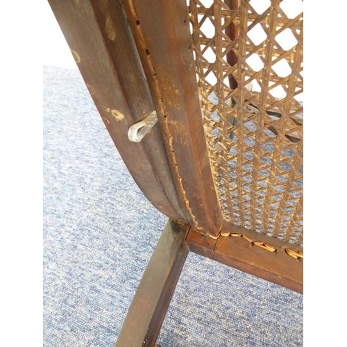 768 - An early 19th century grained (to look like rosewood) open-armed dining chair; the rope-style top-ra... 