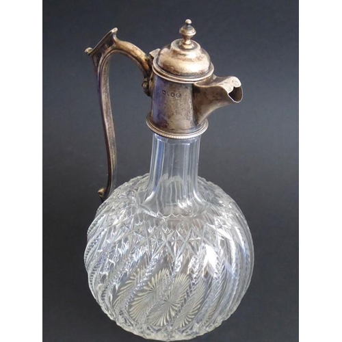 83 - A 19th century cut-glass and silver-mounted globe and shaft-shaped claret jug; ornately engraved gla... 