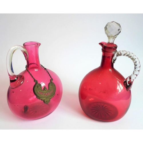 84 - Two 19th century cranberry glass flasks; one with 'Brandy' ticket, together with a spherical cobalt ... 