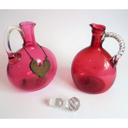 84 - Two 19th century cranberry glass flasks; one with 'Brandy' ticket, together with a spherical cobalt ... 