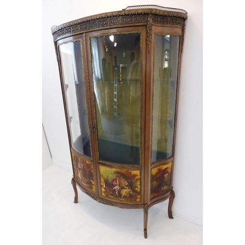 869 - A late 19th / early 20th century two-door vitrine in 18th century French style: bow-fronted, walnut ... 