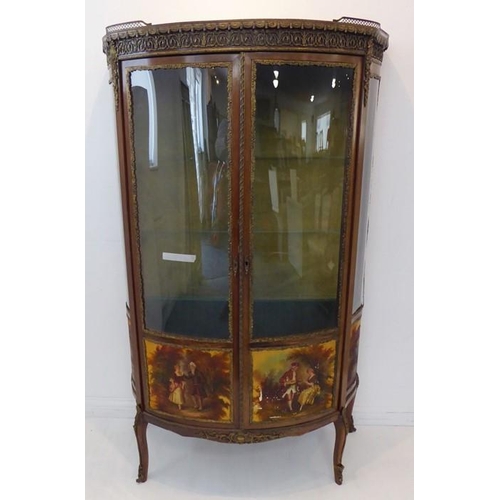 869 - A late 19th / early 20th century two-door vitrine in 18th century French style: bow-fronted, walnut ... 