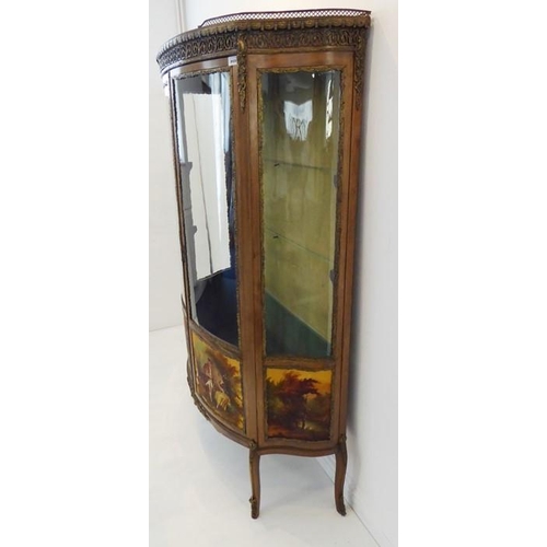 869 - A late 19th / early 20th century two-door vitrine in 18th century French style: bow-fronted, walnut ... 