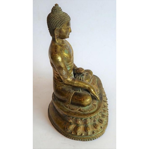 101 - A Tibetan gilt bronze medicine Buddha; the Buddha seated in dhyanasana on a double lotus throne, he ... 