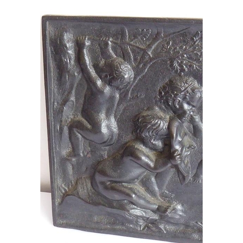 103 - A 19th century cast-iron rectangular plaque; decorated with cherubic figures partaking in Bacchanali... 