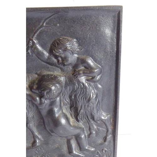 103 - A 19th century cast-iron rectangular plaque; decorated with cherubic figures partaking in Bacchanali... 