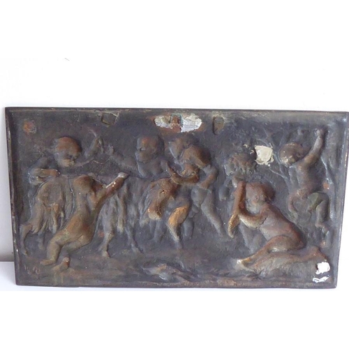 103 - A 19th century cast-iron rectangular plaque; decorated with cherubic figures partaking in Bacchanali... 