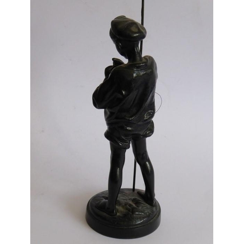 104 - A mid-20th century Russian black-painted ironwork sculpture of a young boy with fishing rod; script ... 