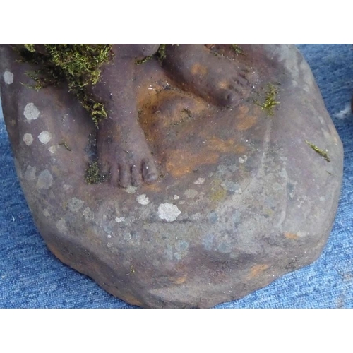 105 - A pair of weathered cast-iron bird baths; modelled as a young boy and girl standing on rockwork and ... 