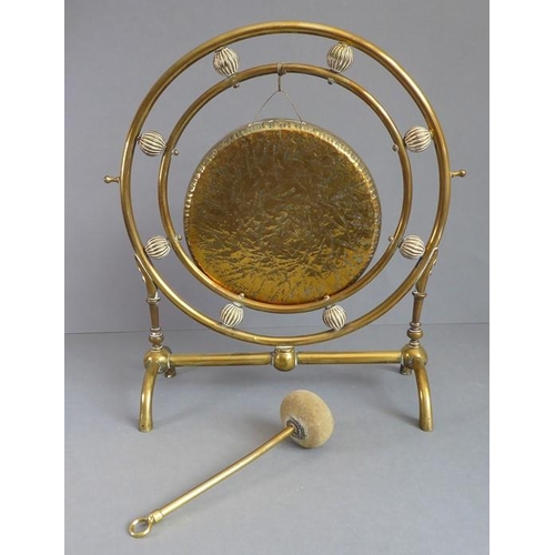 109 - A late 19th century Aesthetic-style brass gong and hammer (34cm high)