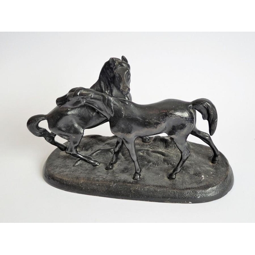 111 - A 20th century Russian painted, cast-iron sculpture model of two horses; marks to underside and date... 