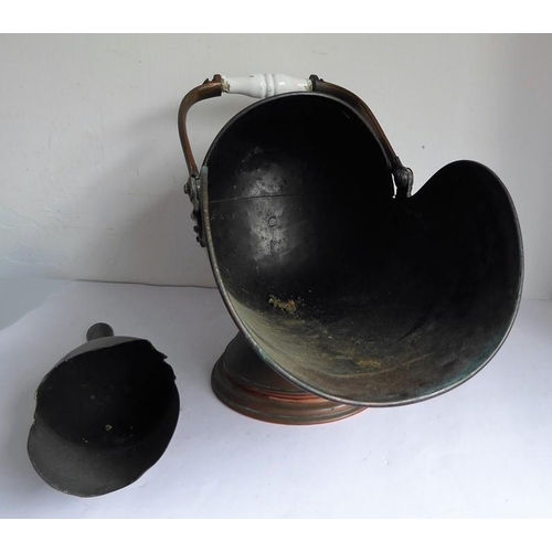 115 - A 19th century helmet-shaped copper coal scuttle and scoop