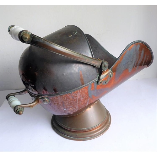 115 - A 19th century helmet-shaped copper coal scuttle and scoop