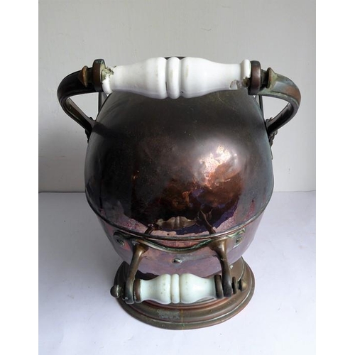 115 - A 19th century helmet-shaped copper coal scuttle and scoop