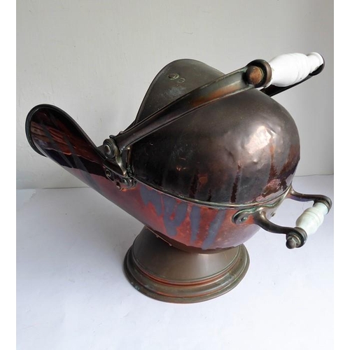 115 - A 19th century helmet-shaped copper coal scuttle and scoop