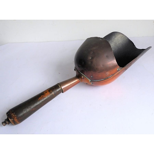 115 - A 19th century helmet-shaped copper coal scuttle and scoop