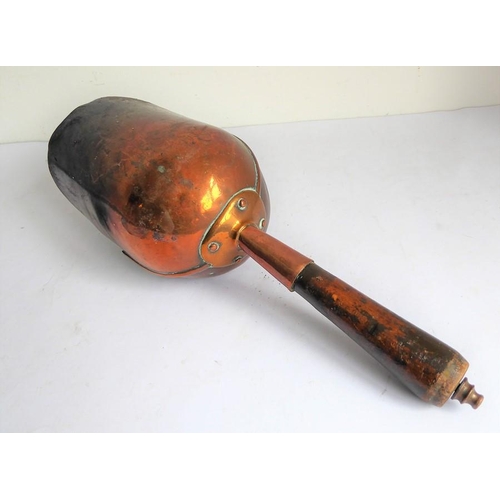 115 - A 19th century helmet-shaped copper coal scuttle and scoop