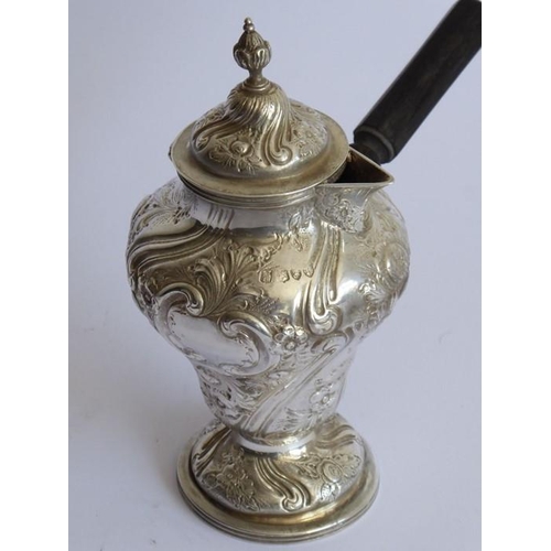 116 - An ornate 19th century hallmarked silver chocolate cup and cover; the hinged top with finial above a... 