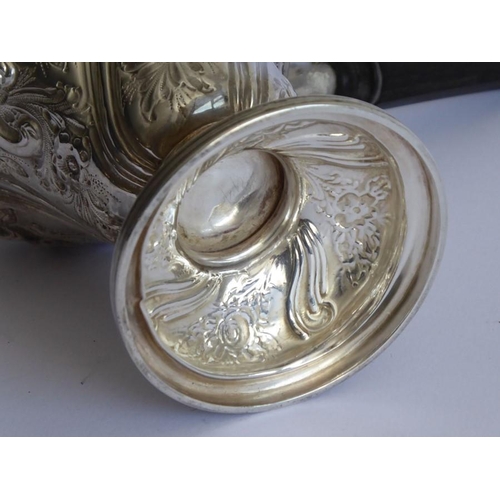 116 - An ornate 19th century hallmarked silver chocolate cup and cover; the hinged top with finial above a... 