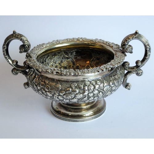 129 - A heavy early 19th century hallmarked silver three-piece tea service: teapot, large two-handled suga... 