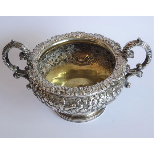 129 - A heavy early 19th century hallmarked silver three-piece tea service: teapot, large two-handled suga... 