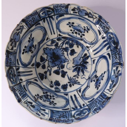 13 - A Kangxi-period Chinese porcelain bowl; hand-decorated in underglaze blue, the interior with four qu... 