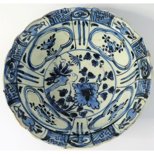 13 - A Kangxi-period Chinese porcelain bowl; hand-decorated in underglaze blue, the interior with four qu... 