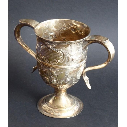 137 - An 18th century hallmarked silver two-handled trophy-style cup; later Repoussé decorated and with in... 