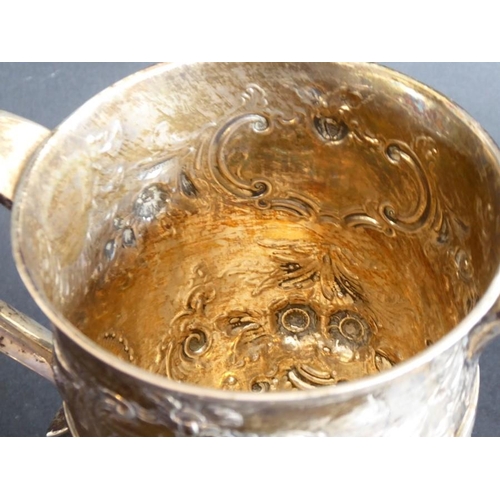 137 - An 18th century hallmarked silver two-handled trophy-style cup; later Repoussé decorated and with in... 