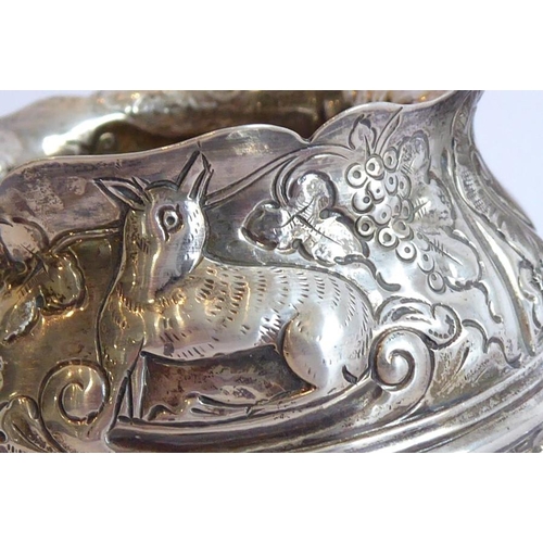 144 - Three pieces of hallmarked silver: a 19th century cauldron-shaped sugar bowl decorated in repoussé s... 