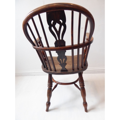 766 - A mid-19th century yew wood Windsor chair; pierced shaped splat, shaped elm seat and turned slightly... 