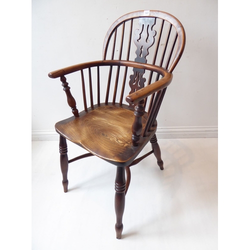 767 - A mid-19th century yew wood Windsor chair; having pierced splat, shaped elm seat and turned legs uni... 