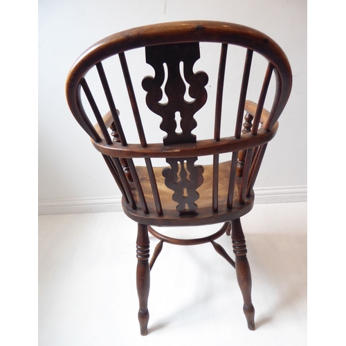 767 - A mid-19th century yew wood Windsor chair; having pierced splat, shaped elm seat and turned legs uni... 