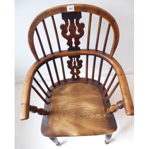 767 - A mid-19th century yew wood Windsor chair; having pierced splat, shaped elm seat and turned legs uni... 