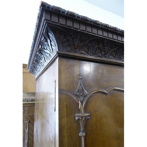 867 - An early 20th century Chippendale-style two-door mahogany wardrobe; the gadrooned and dentil cornice... 