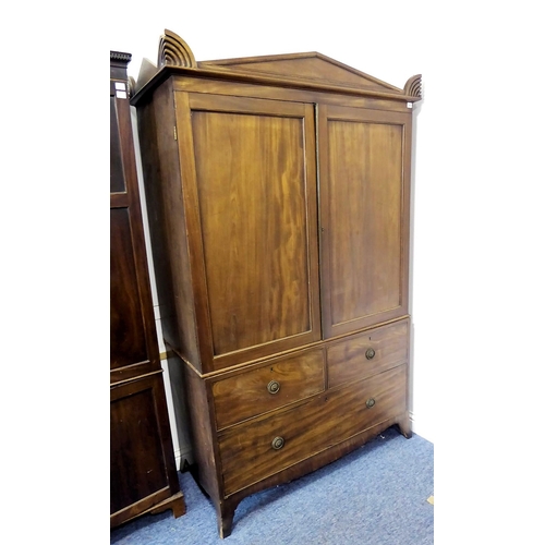 867 - An early 20th century Chippendale-style two-door mahogany wardrobe; the gadrooned and dentil cornice... 