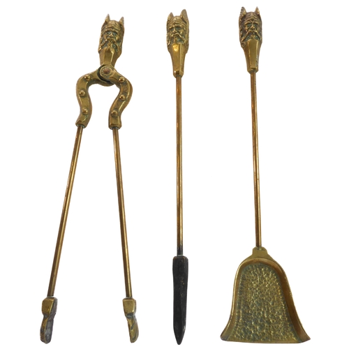 66 - An unusual set of early 20th century heavy brass fireirons: each handle modelled as a heavily cast V... 