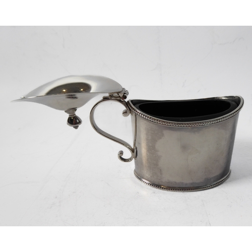 87 - A large hallmarked silver mustard of oval form and with heavy cobalt blue glass liner, maker's mark ... 