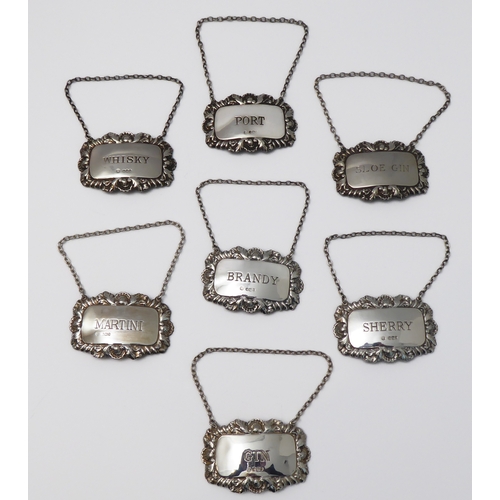 106 - Seven modern hallmarked silver wine/spirit tickets to include Sherry, Martini, Gin, Whiskey, Brandy,... 
