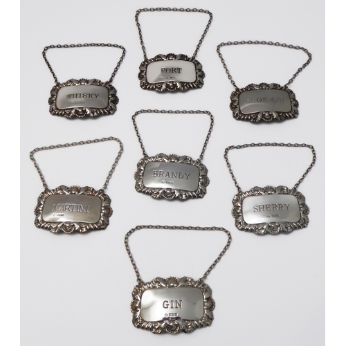 106 - Seven modern hallmarked silver wine/spirit tickets to include Sherry, Martini, Gin, Whiskey, Brandy,... 
