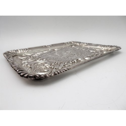 110 - A hallmarked silver trinket tray - decorated in repoussé style in relief with five winged cherubic h... 