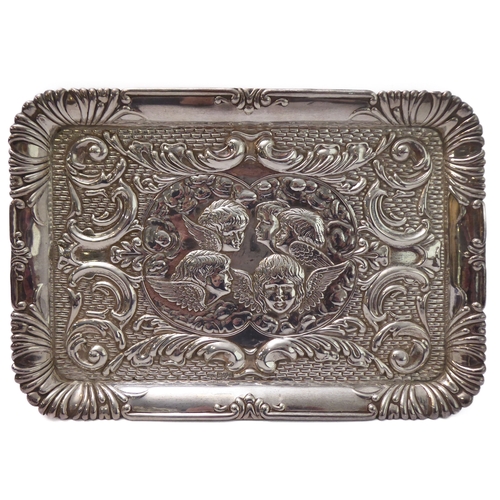 110 - A hallmarked silver trinket tray - decorated in repoussé style in relief with five winged cherubic h... 