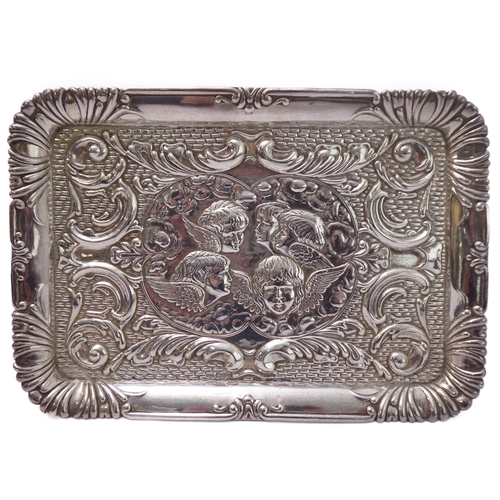 110 - A hallmarked silver trinket tray - decorated in repoussé style in relief with five winged cherubic h... 