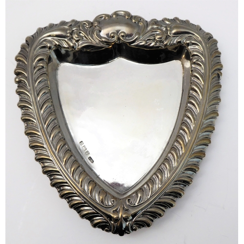 112 - Silverware comprising a heart-shaped trinket dish with raised repoussé-style foliate border and vaca... 